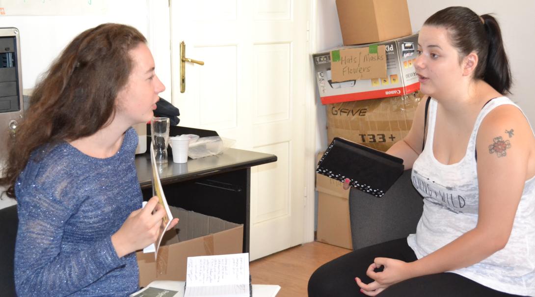 Teenage volunteer chat with each other about different interview techniques during their Journalism Project Journalism volunteers practice their interviewing skills as part of their project in Romania